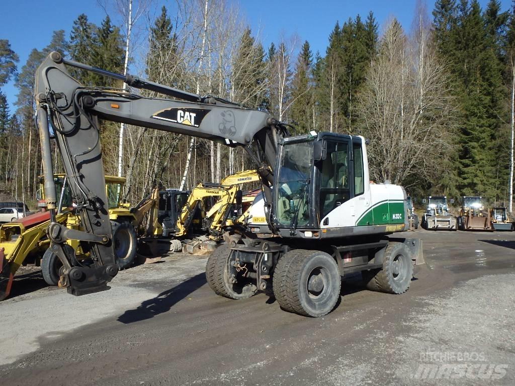 CAT M 313 C 4x4 حفارات بعجل