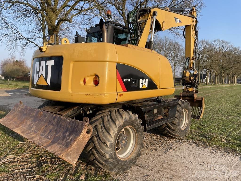 CAT M 313 D حفارات بعجل
