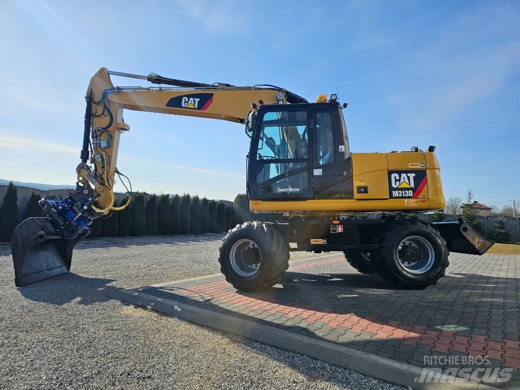 CAT M 313 D حفارات بعجل