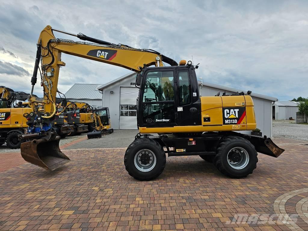 CAT M 313 D حفارات بعجل