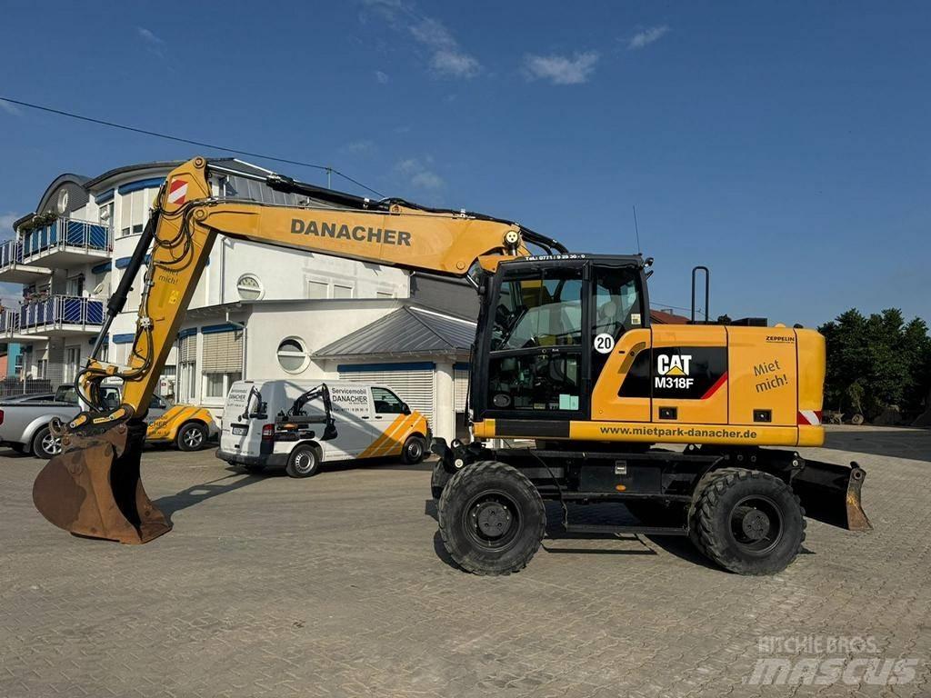 CAT M 318 F حفارات بعجل