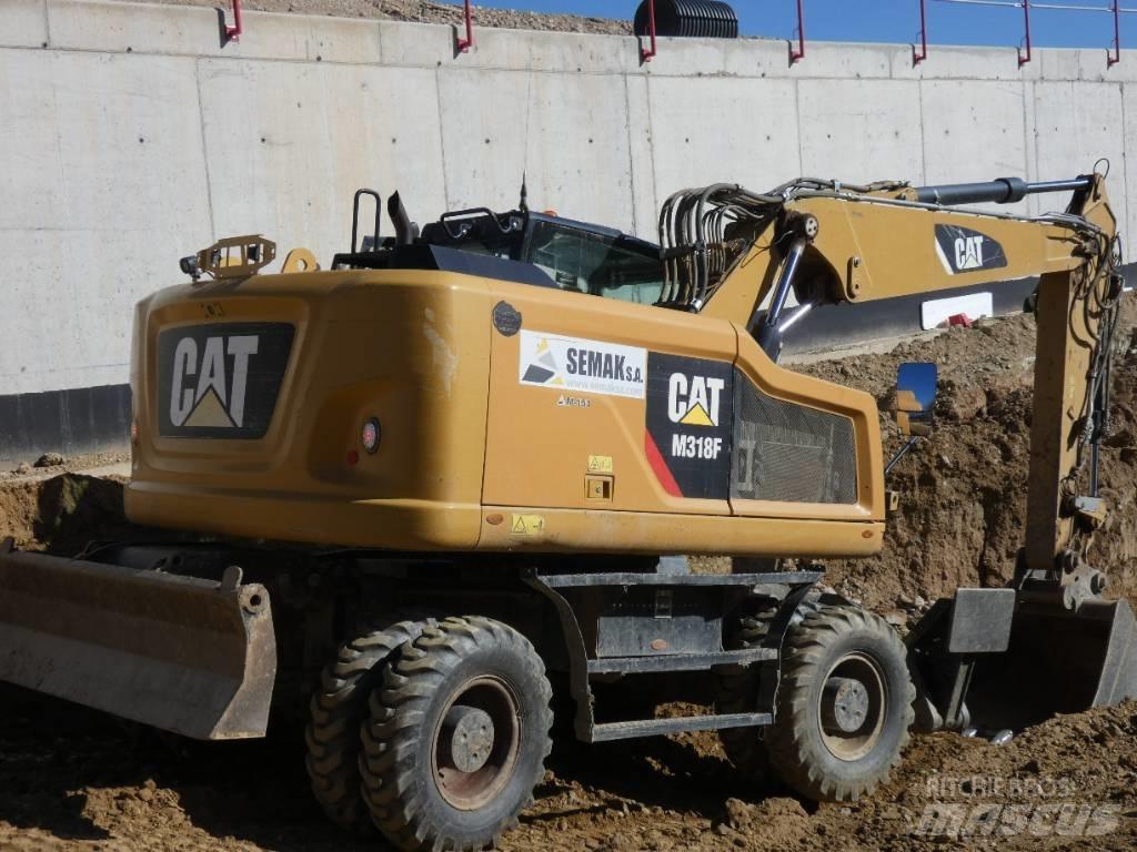 CAT M 318 F حفارات بعجل