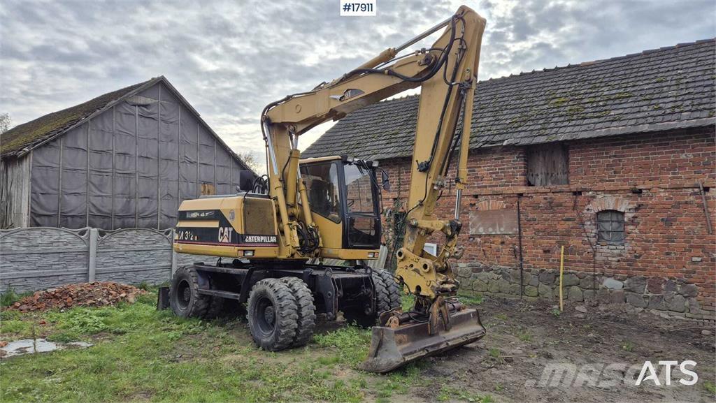 CAT M312 حفارات بعجل