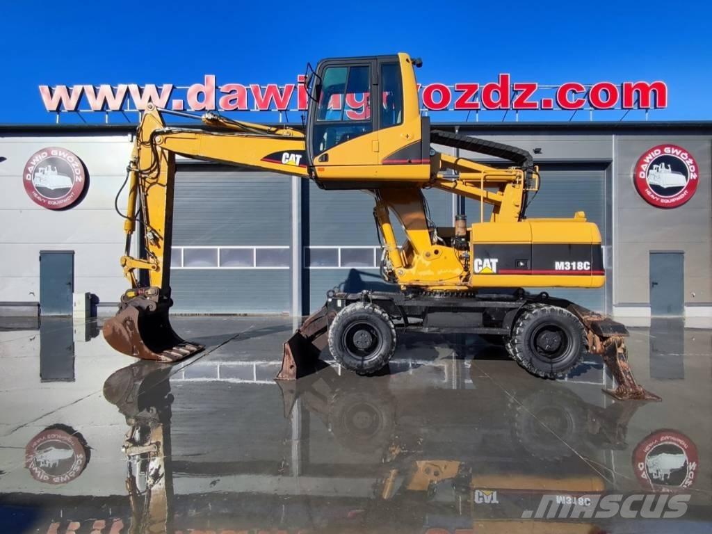 CAT M 318 C حفارات بعجل