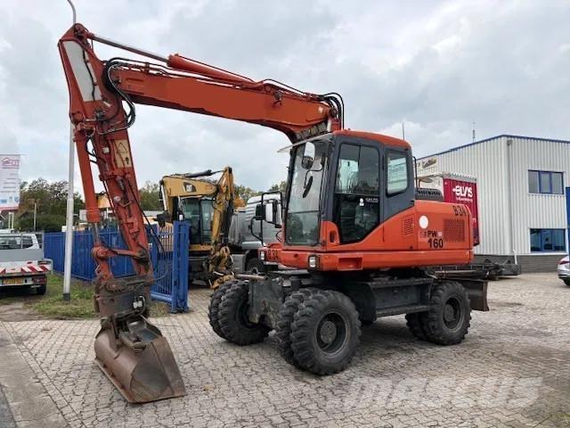 Komatsu PW 160 - 7EO حفارات بعجل