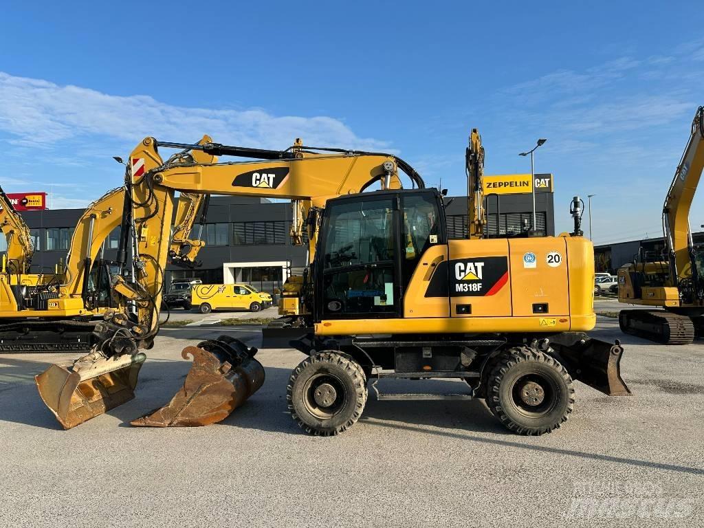 CAT M 318 F حفارات بعجل