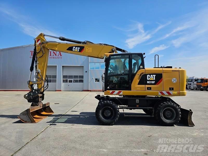 CAT M 318 F حفارات بعجل