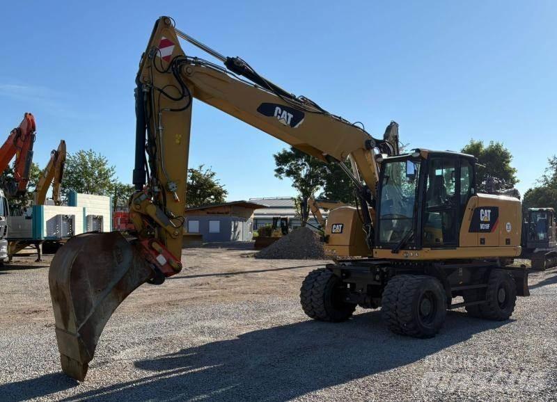 CAT M318F حفارات بعجل