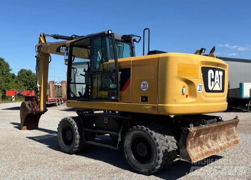 CAT M318F حفارات بعجل