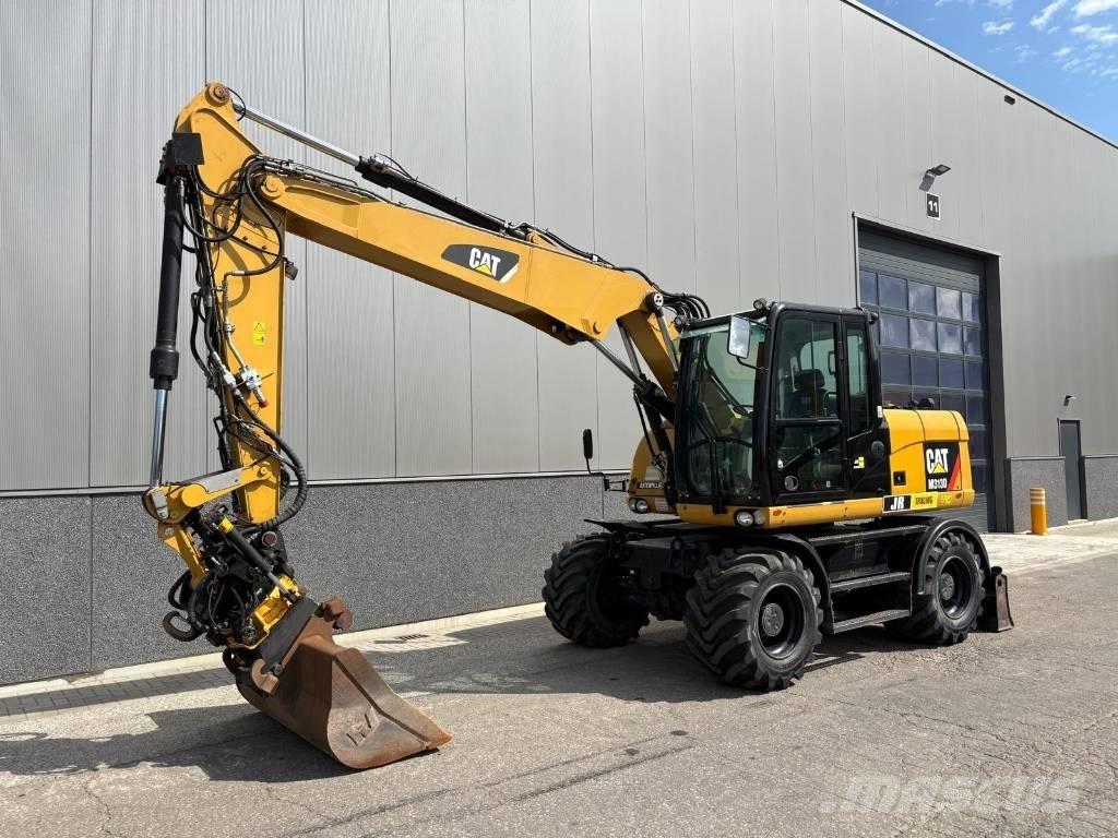CAT M 313 D حفارات بعجل