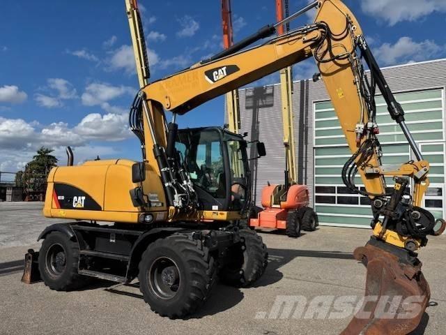 CAT M 313 D حفارات بعجل