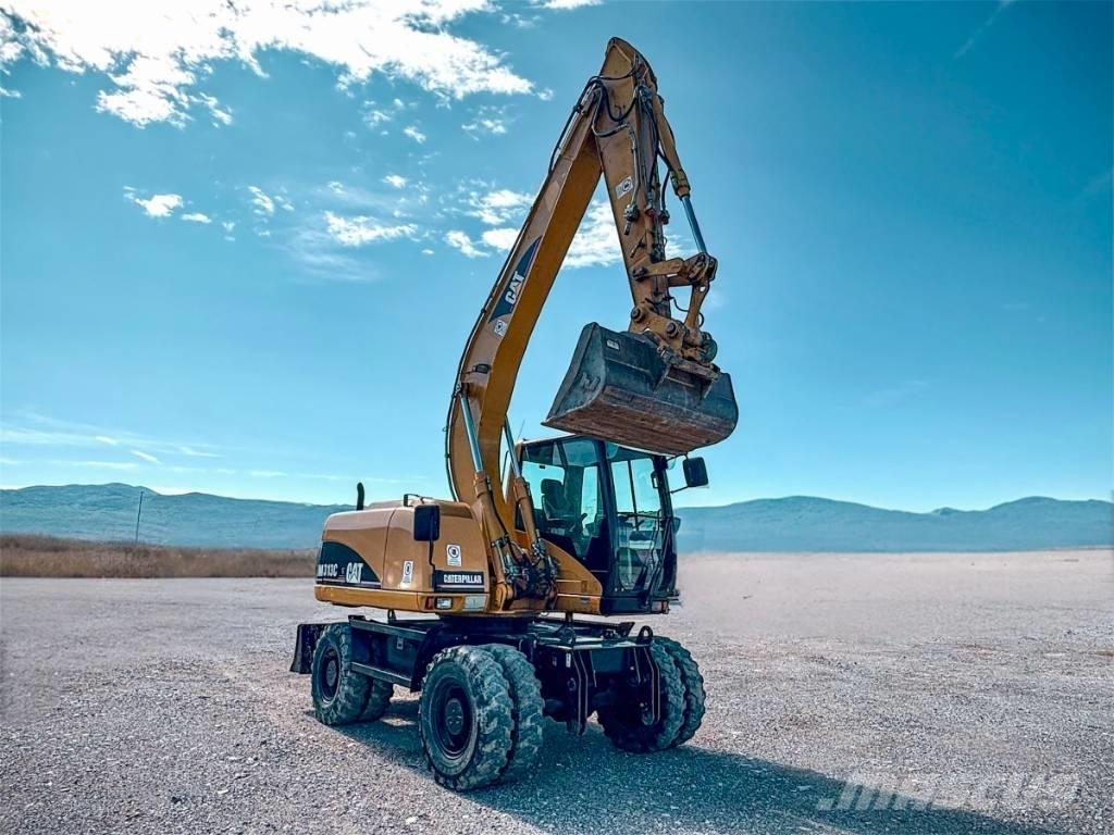 CAT M 313 C حفارات بعجل