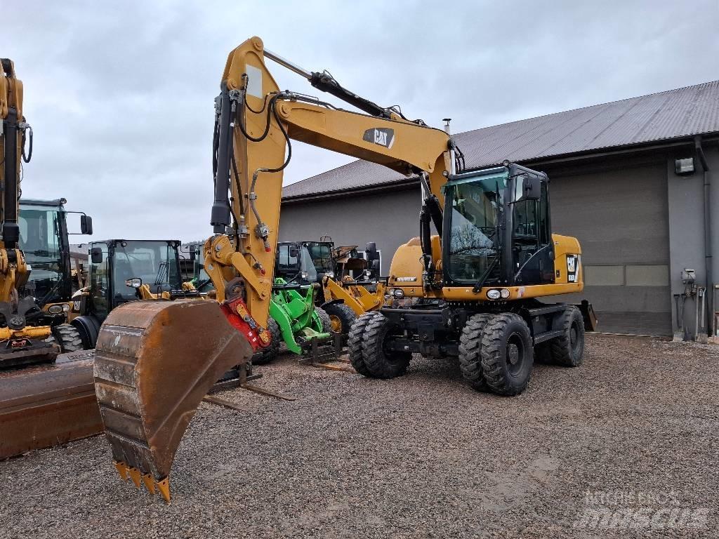 CAT M 313 D حفارات بعجل
