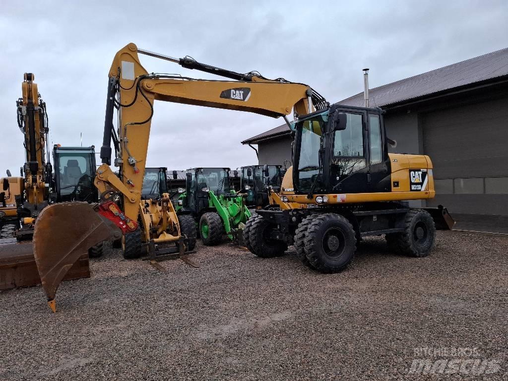 CAT M 313 D حفارات بعجل
