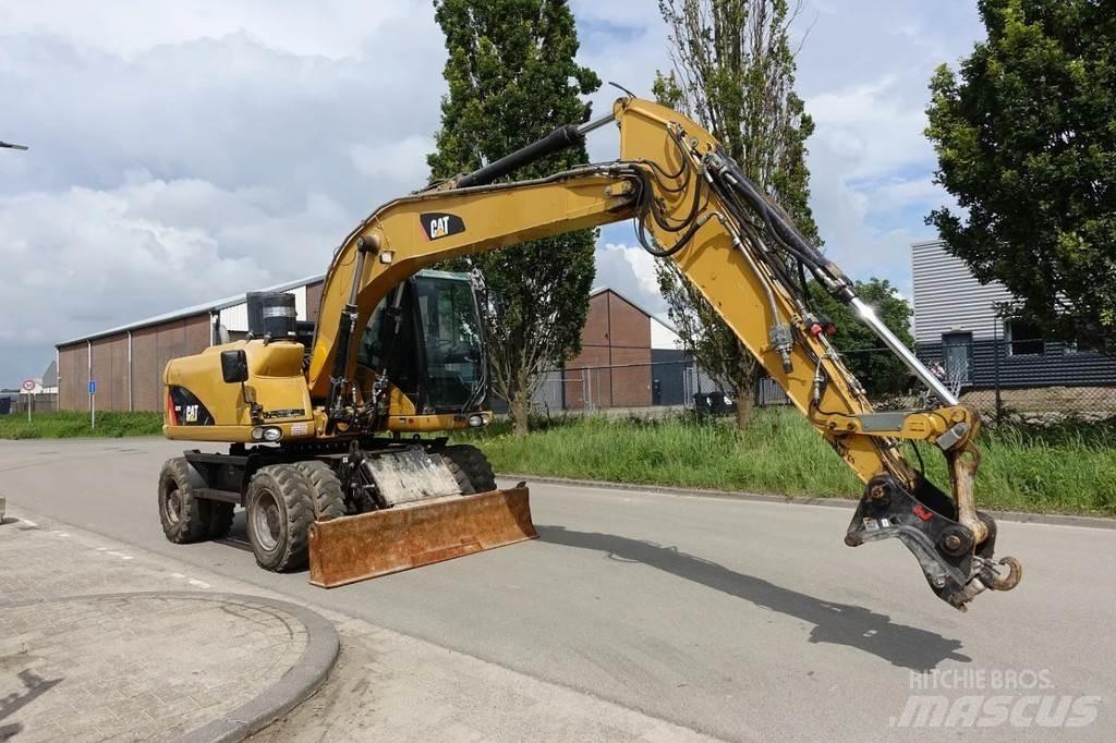 CAT M313 D حفارات بعجل