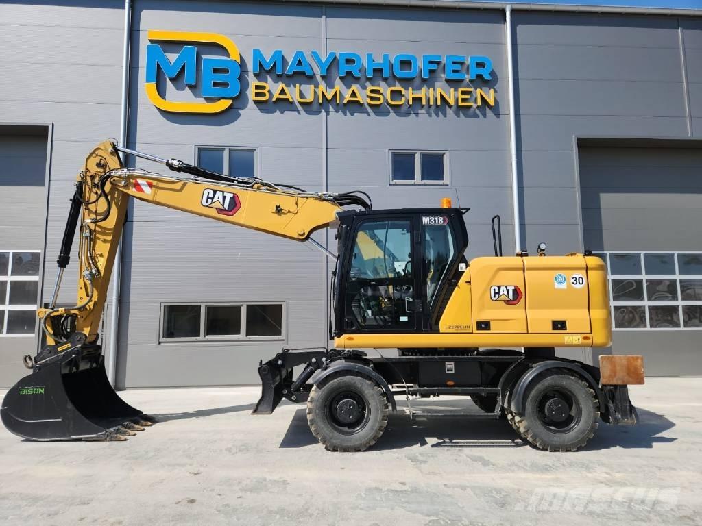 CAT M 318 حفارات بعجل
