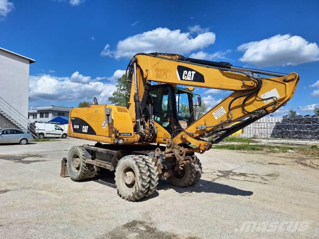 CAT M 315 D حفارات بعجل