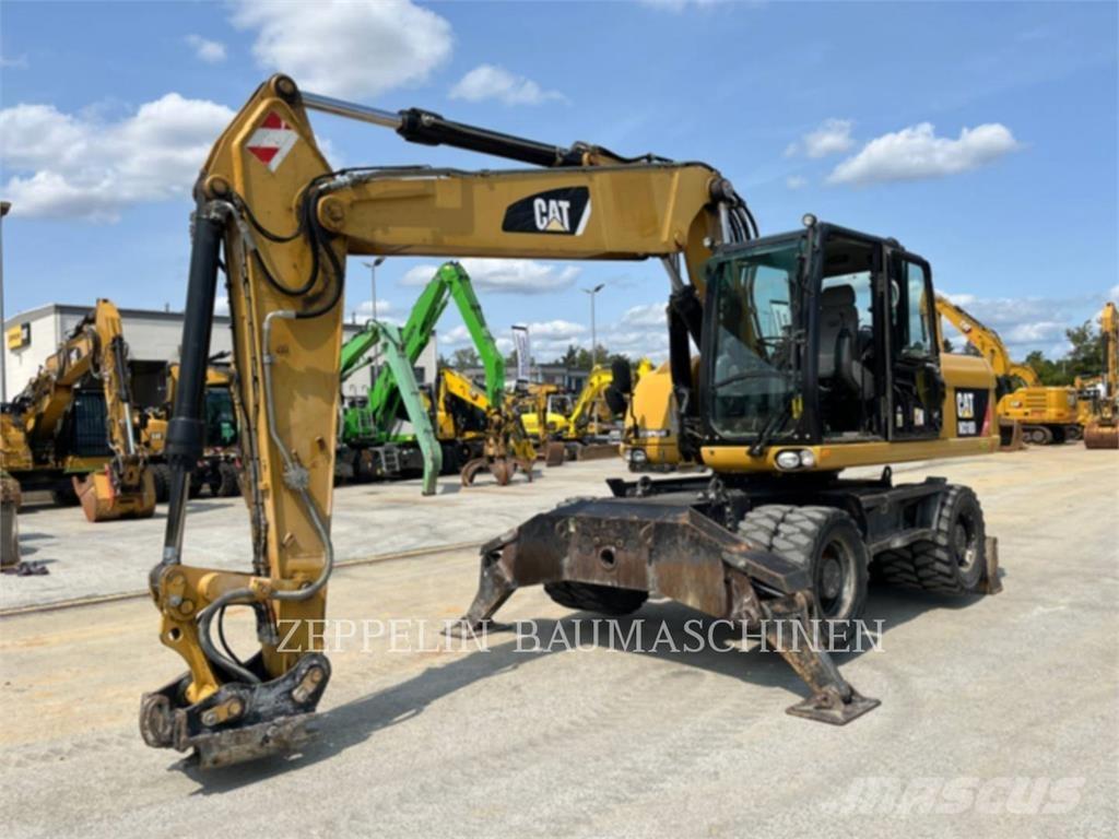 CAT M318D حفارات بعجل