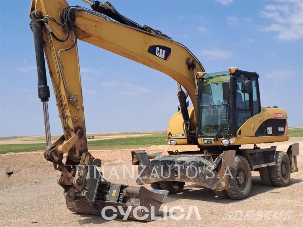 CAT M318D حفارات بعجل