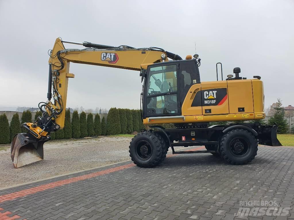 CAT M 318 F حفارات بعجل
