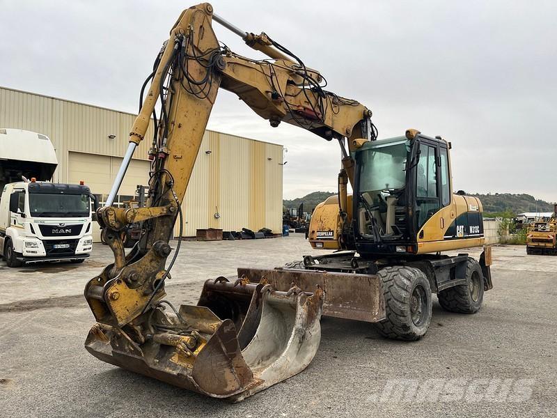 CAT M313C حفارات بعجل