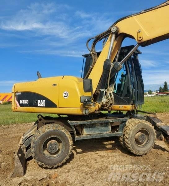 CAT M318 D حفارات بعجل