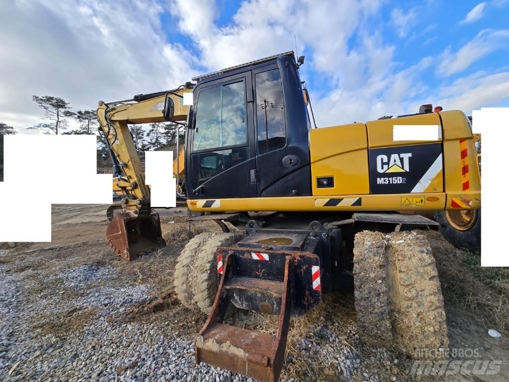 CAT M 315 D حفارات بعجل