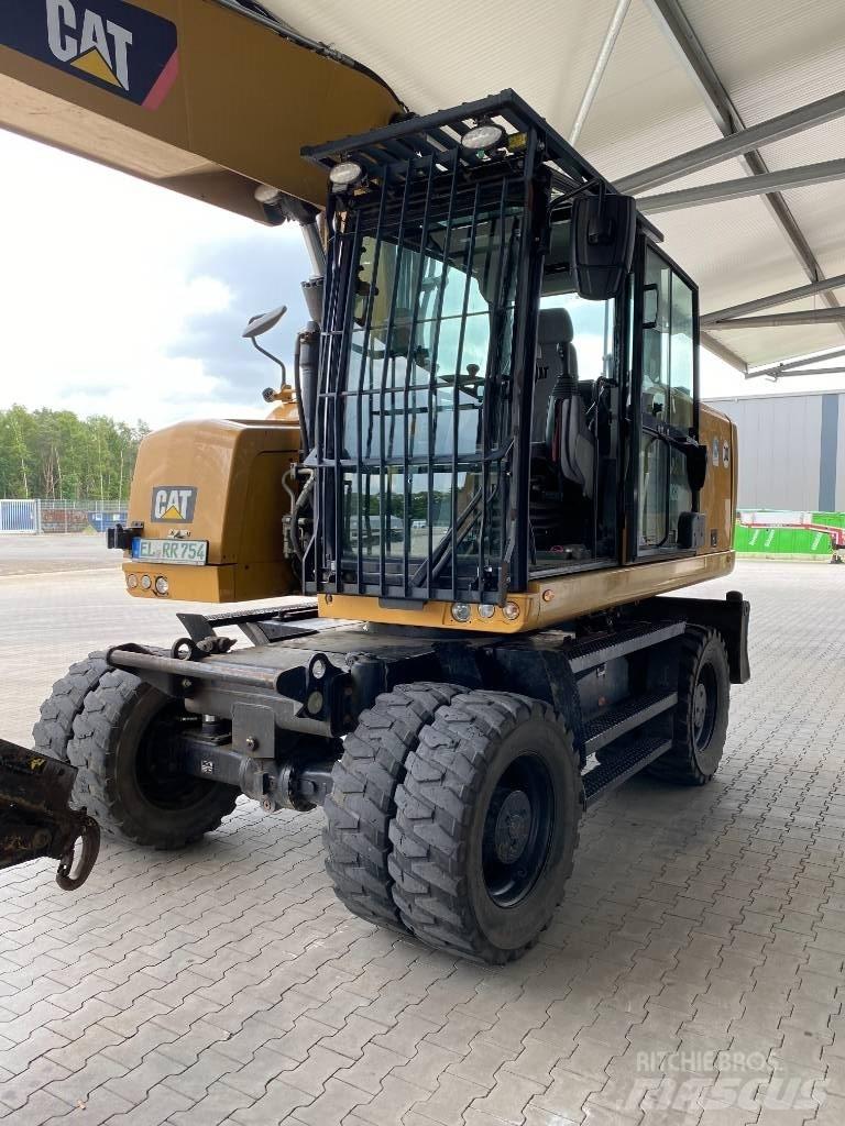 CAT M 320 F حفارات بعجل