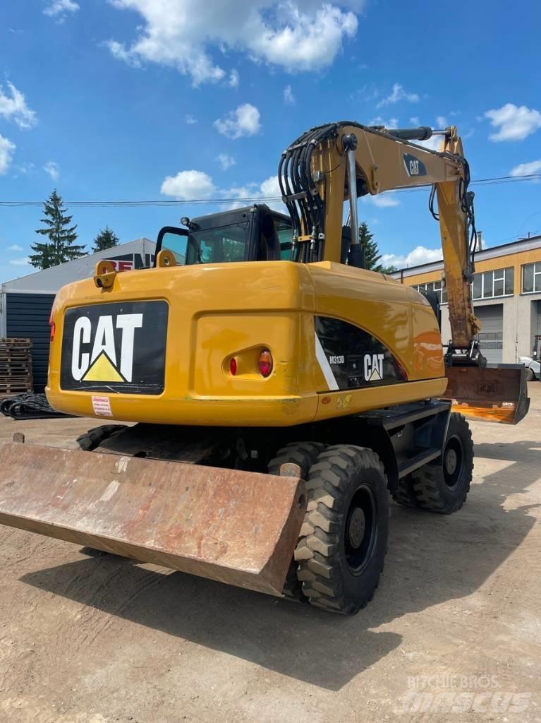 CAT M 313 D حفارات بعجل