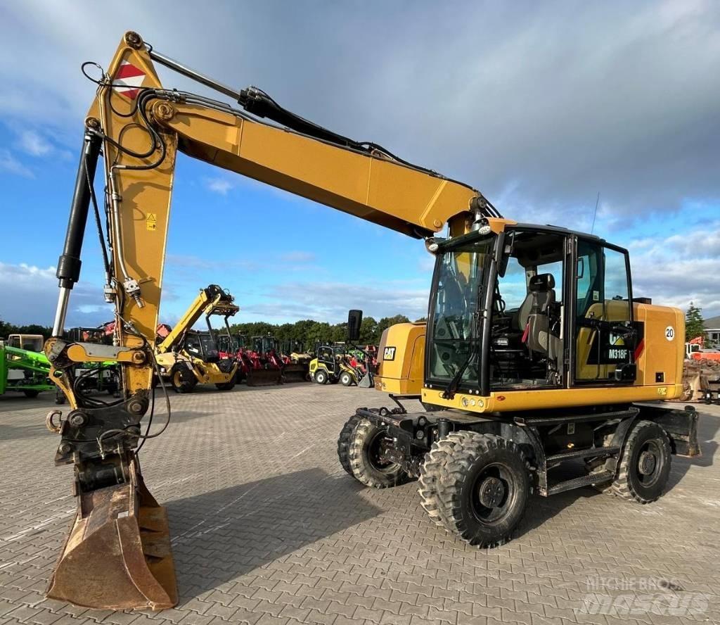 CAT M 318 F حفارات بعجل