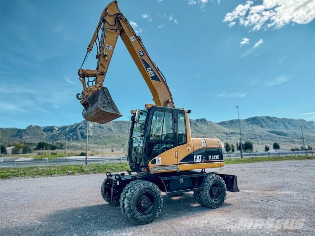 CAT M 313 C حفارات بعجل