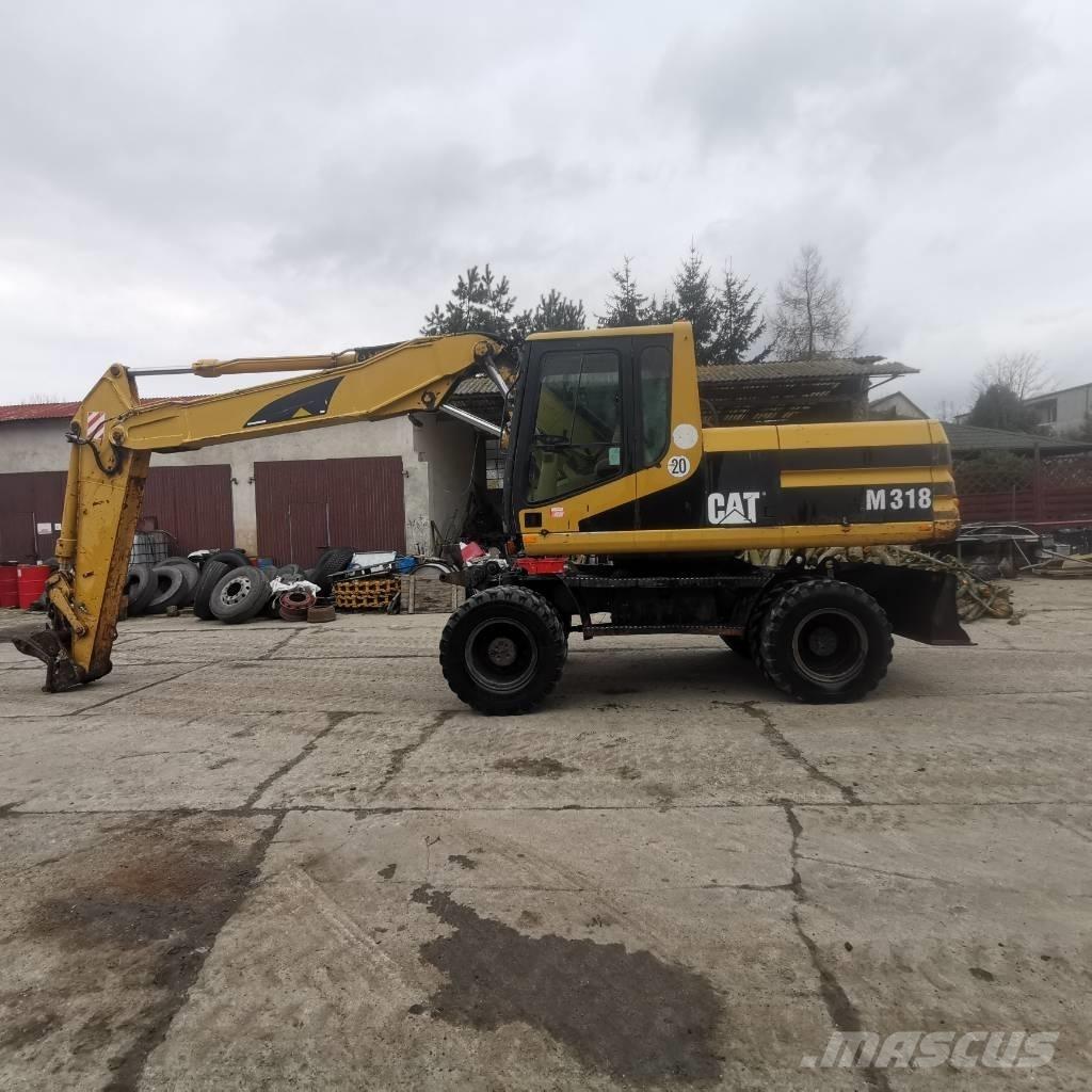 CAT M 318 B حفارات بعجل