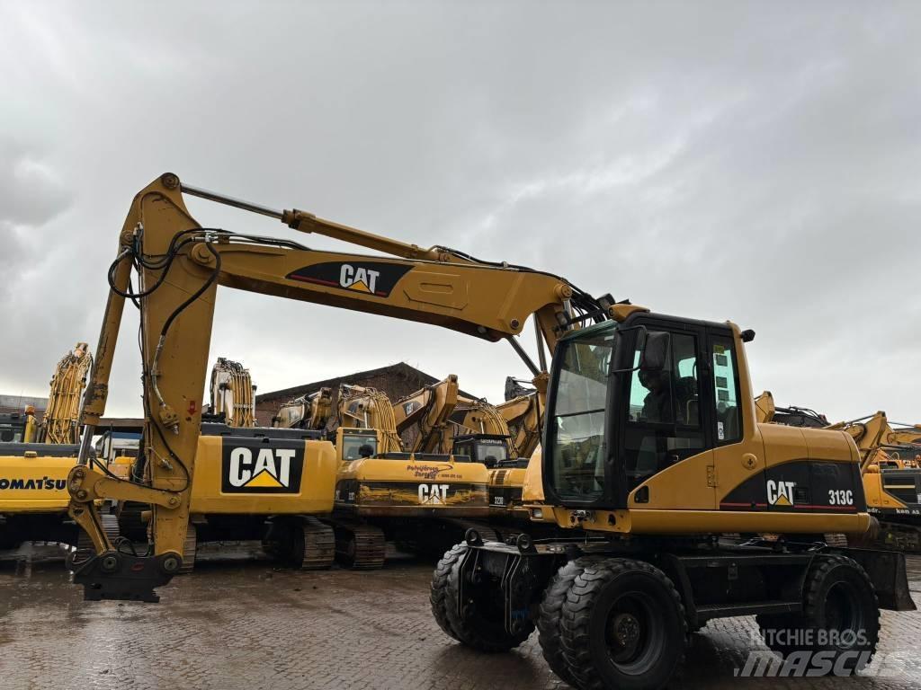 CAT M 313 C حفارات بعجل