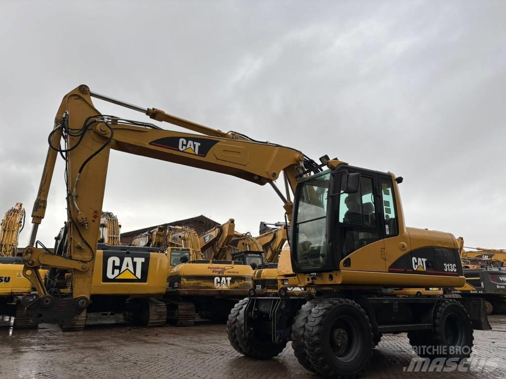 CAT M 313 C حفارات بعجل
