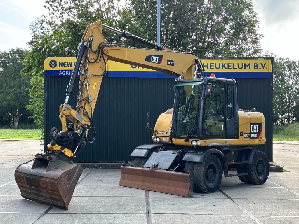CAT M 313 D حفارات بعجل