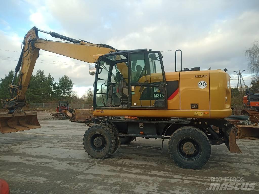 CAT M 318 F حفارات بعجل