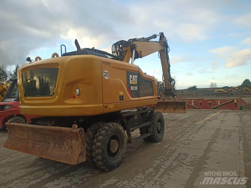 CAT M 318 F حفارات بعجل