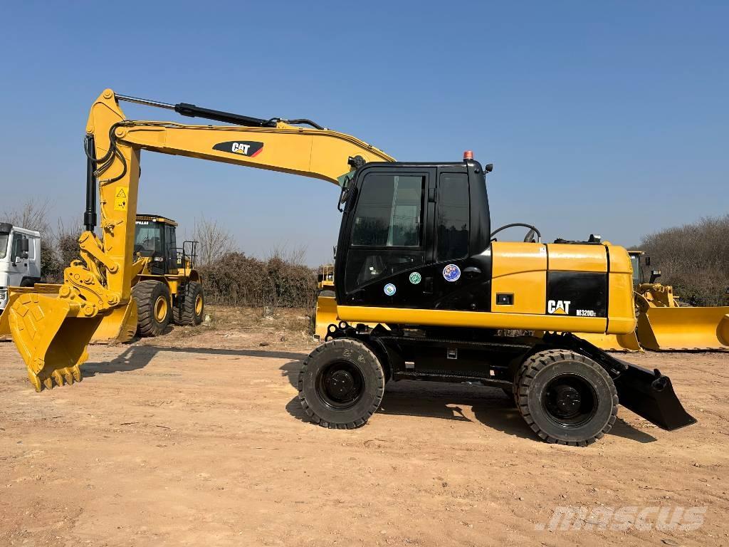 CAT M 320D حفارات بعجل