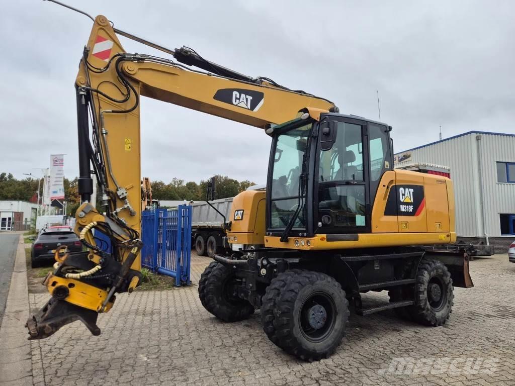 CAT M 318 F حفارات بعجل