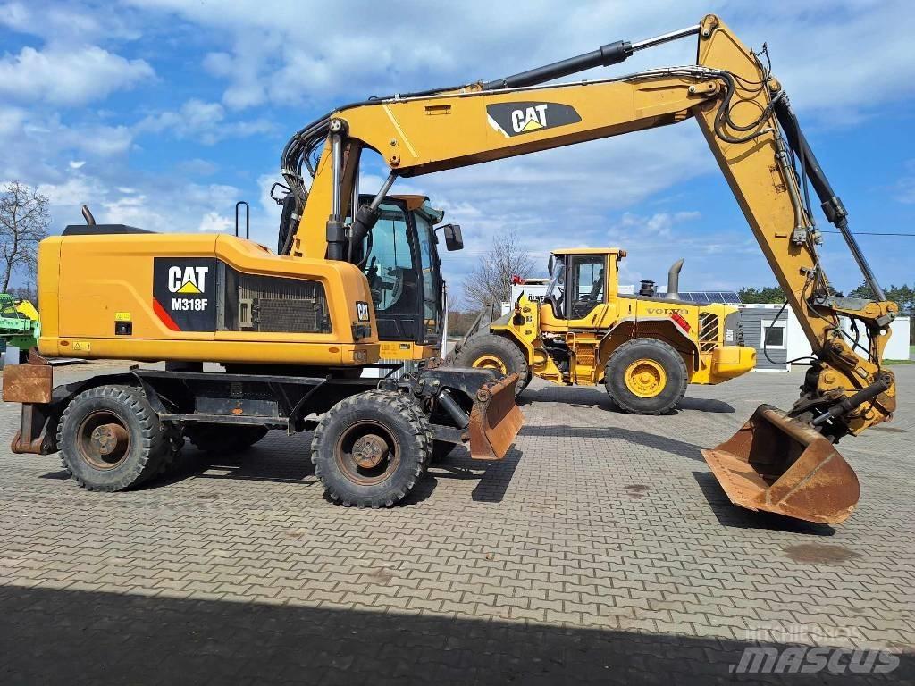 CAT M 318 F حفارات بعجل