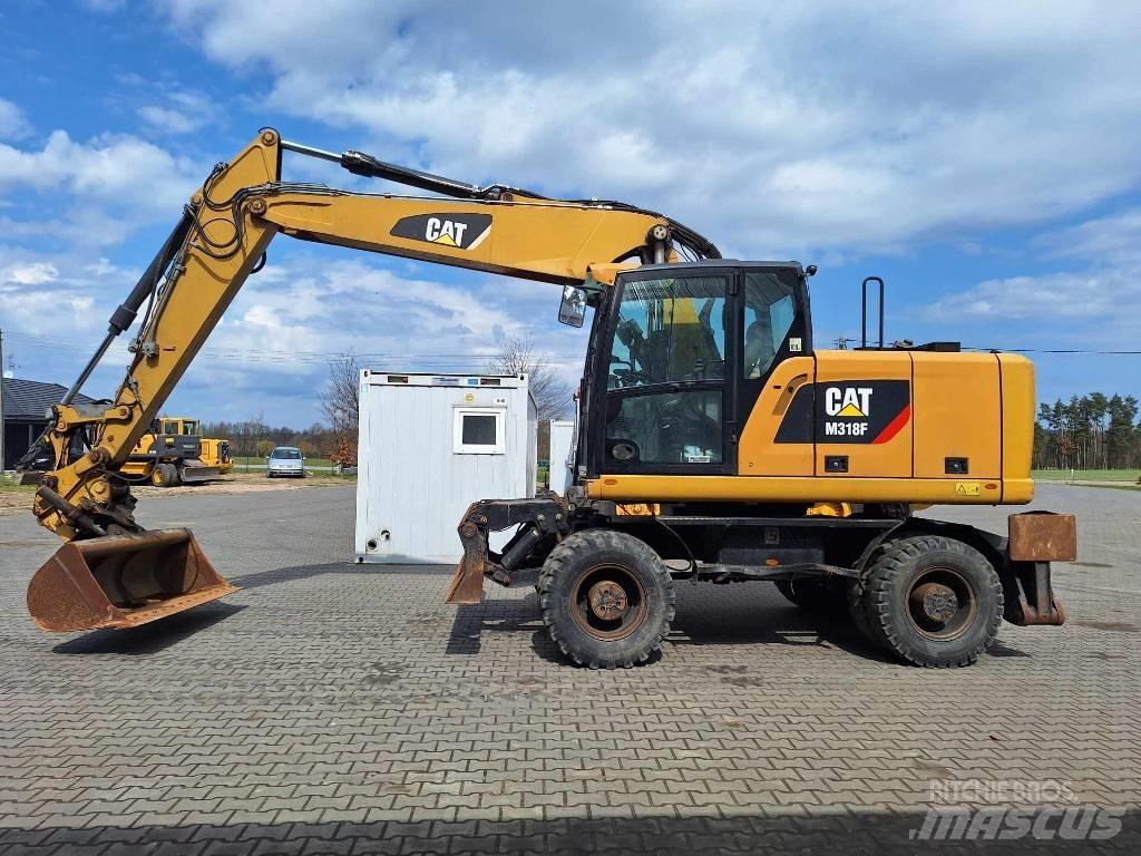 CAT M 318 F حفارات بعجل