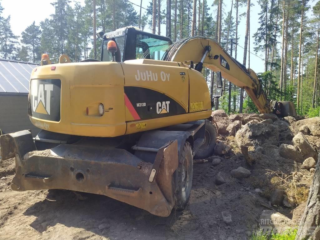 CAT M 313 D حفارات بعجل