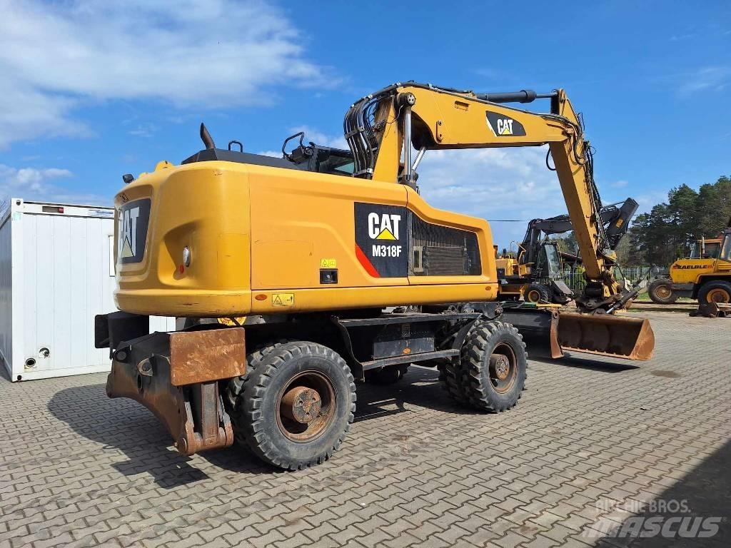 CAT M 318 F حفارات بعجل