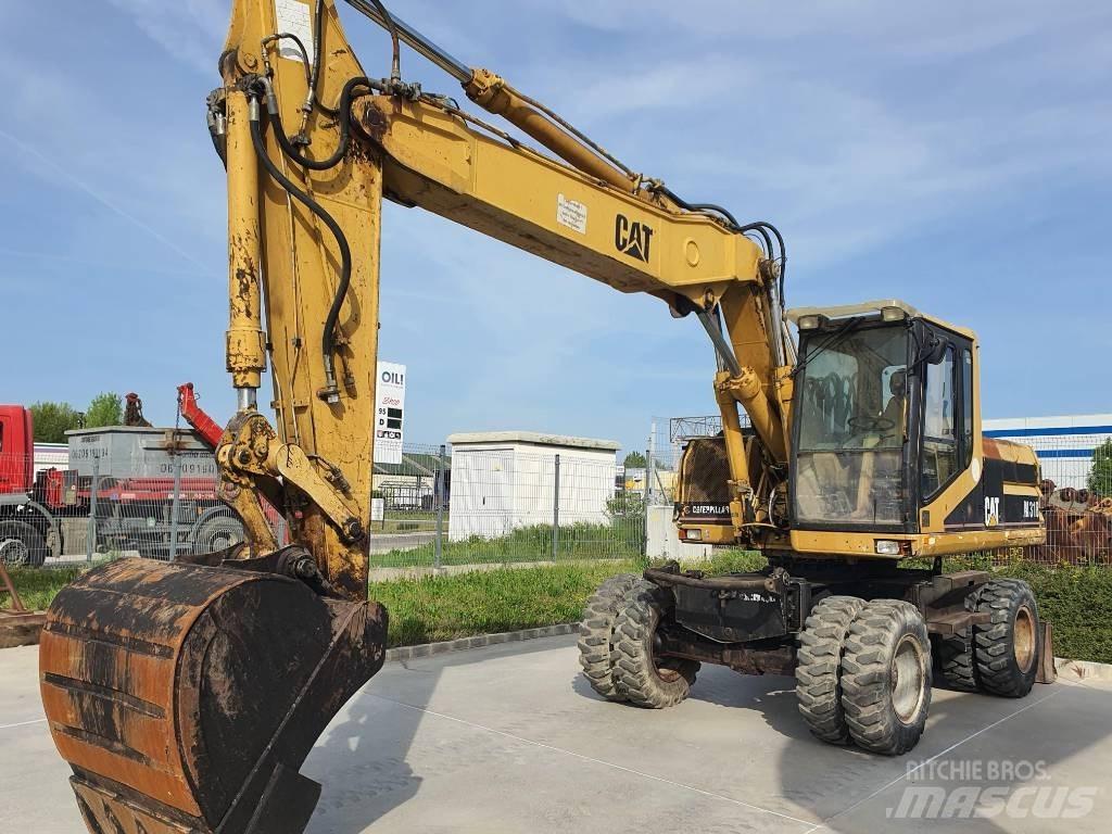 CAT M 318 حفارات بعجل
