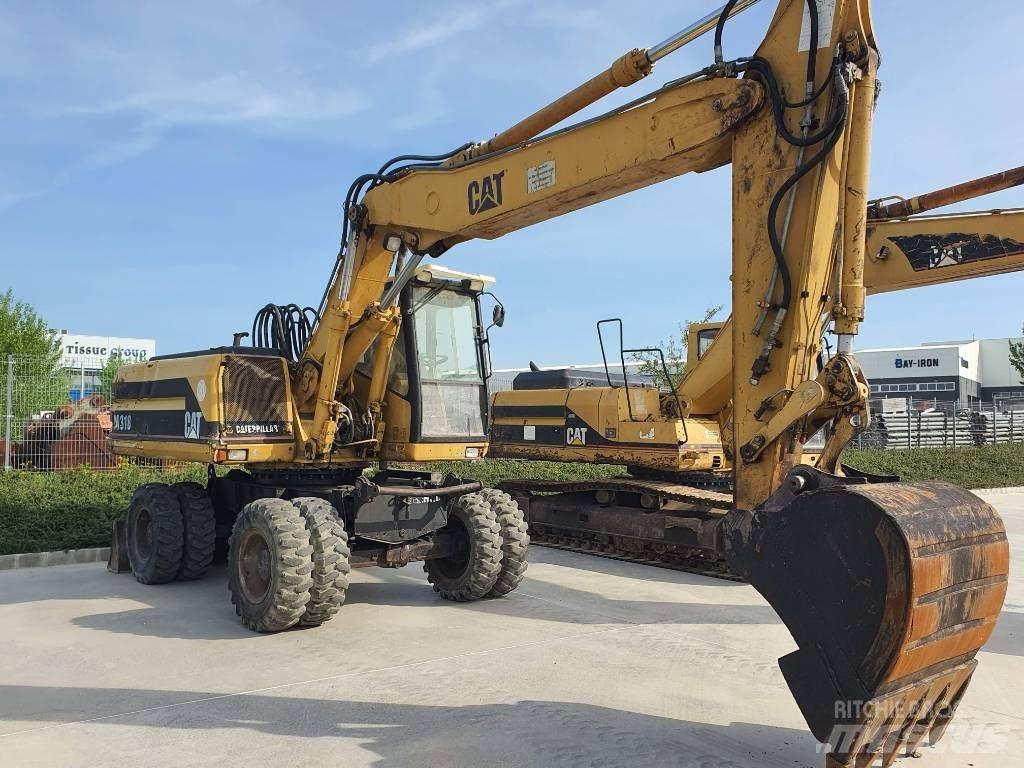 CAT M 318 حفارات بعجل