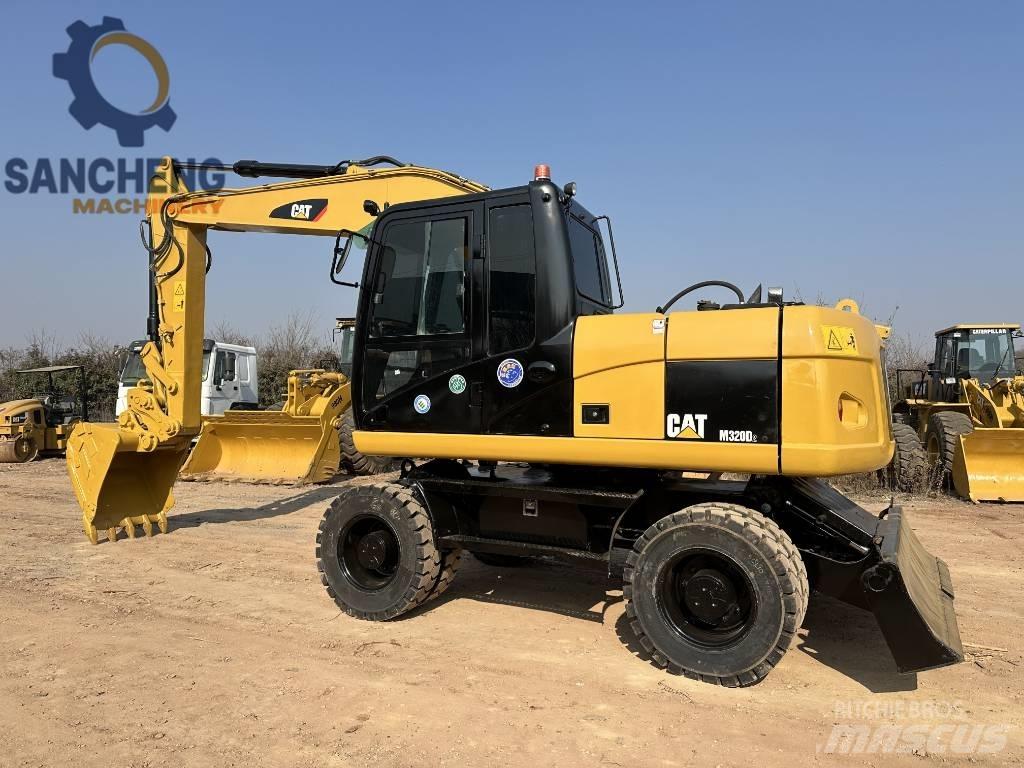 CAT M 320 D حفارات بعجل