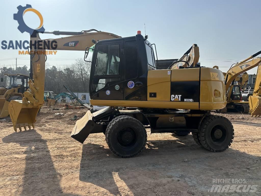CAT M 320 D حفارات بعجل