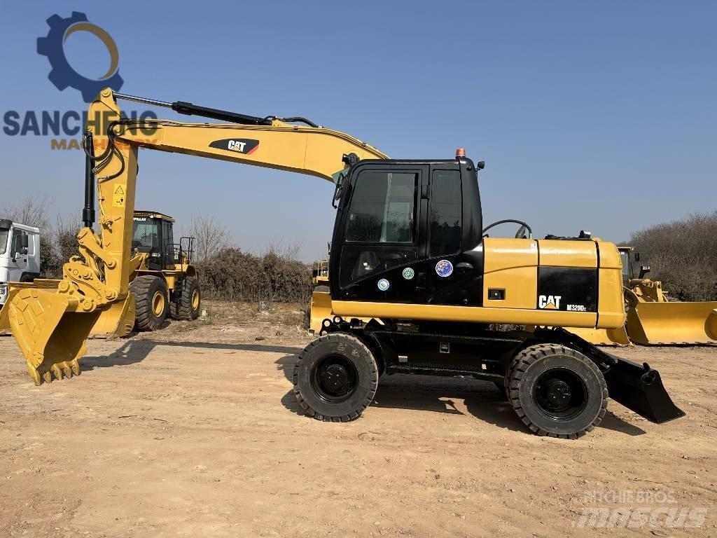 CAT M 320 D2 حفارات بعجل
