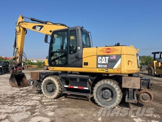 CAT M315D حفارات بعجل