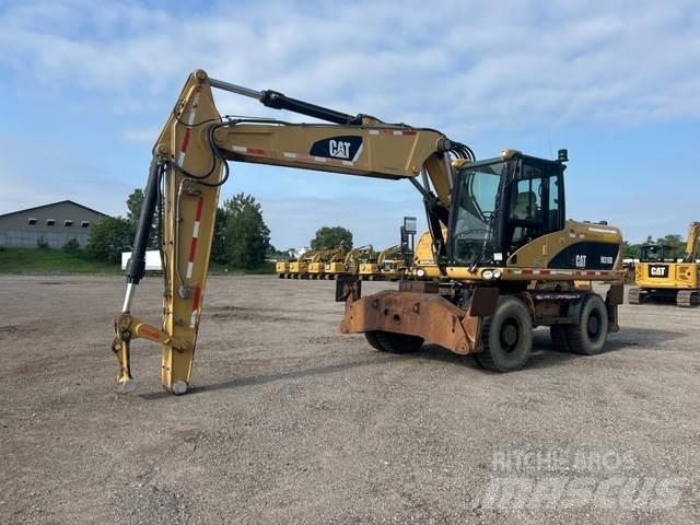 CAT M318D حفارات بعجل
